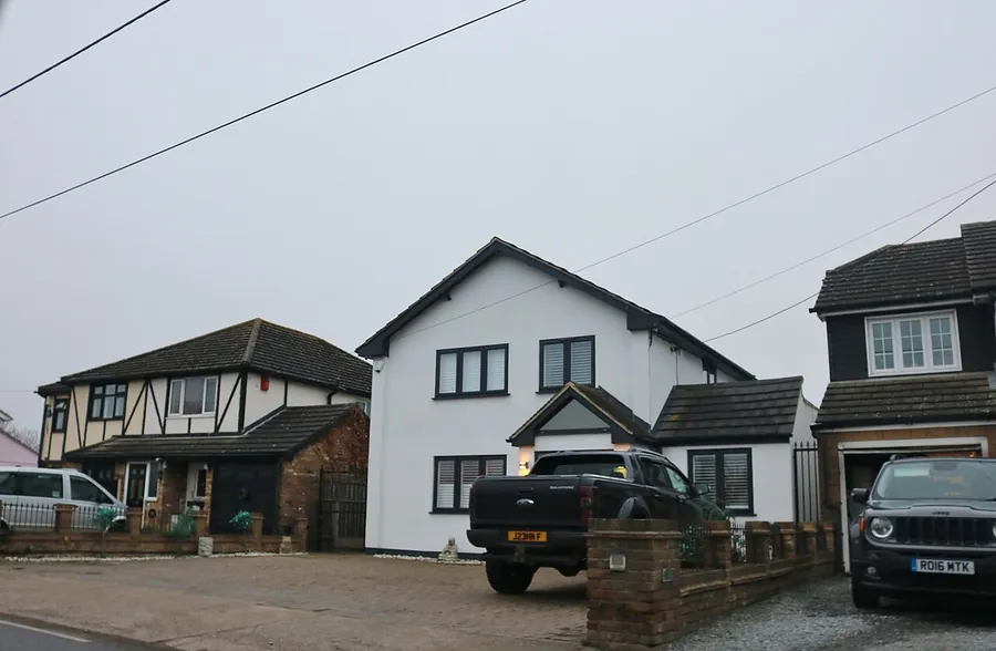 Houses on Hacton Lane in Upminster with gravel and paved front driveways of different ages