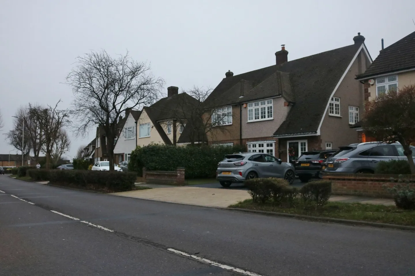 Interwar semi-detached houses on Avon Road in Upminster with cars parked on their front driveways